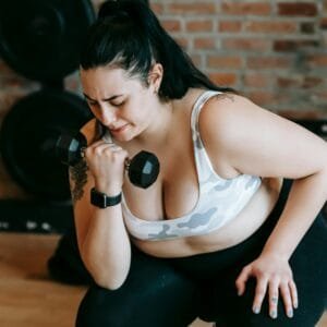 Beginner executing dumbbell shoulder press in their workout routine