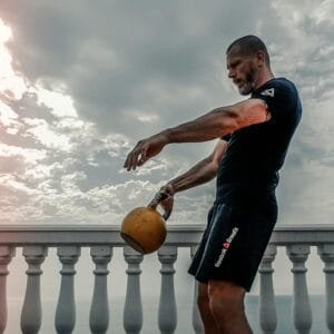 Beginner practicing kettlebell swings in a workout for beginners