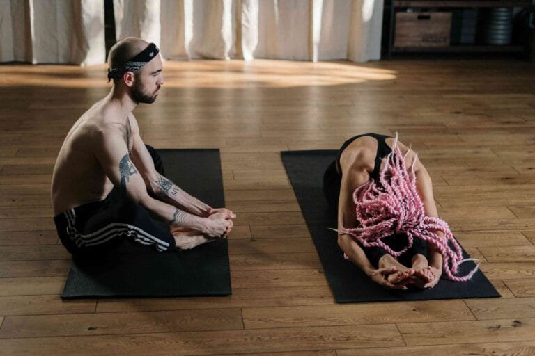 Two individuals practicing yoga together, embodying community and wellness at TM eCommerce Project