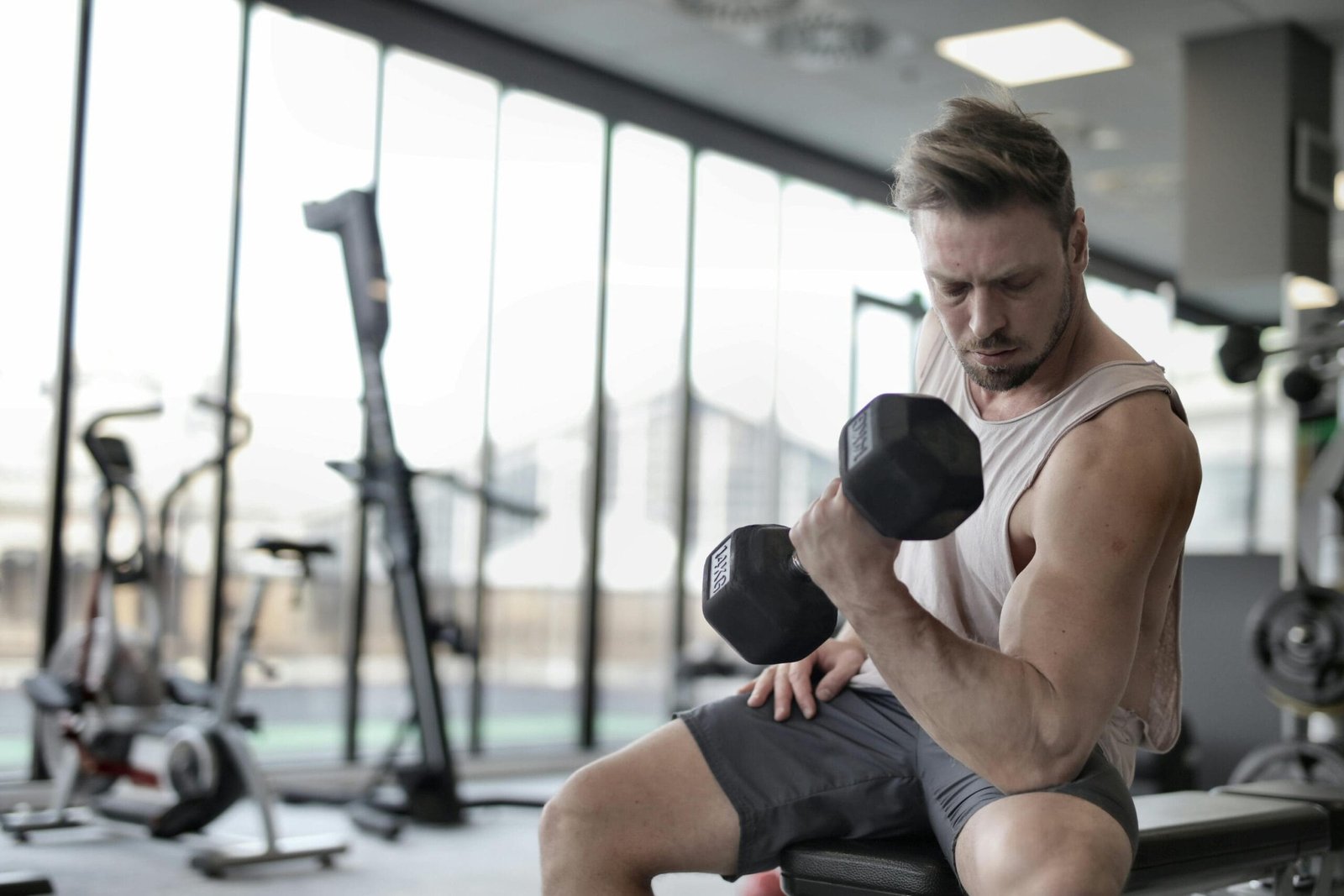 Person performing a bicep curl with dumbbells at home