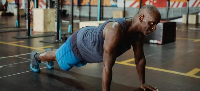 Fitness enthusiast doing push-ups, an essential bodyweight exercise for upper body strength and stability
